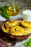 Homemade potato patties with herbs and green onion.