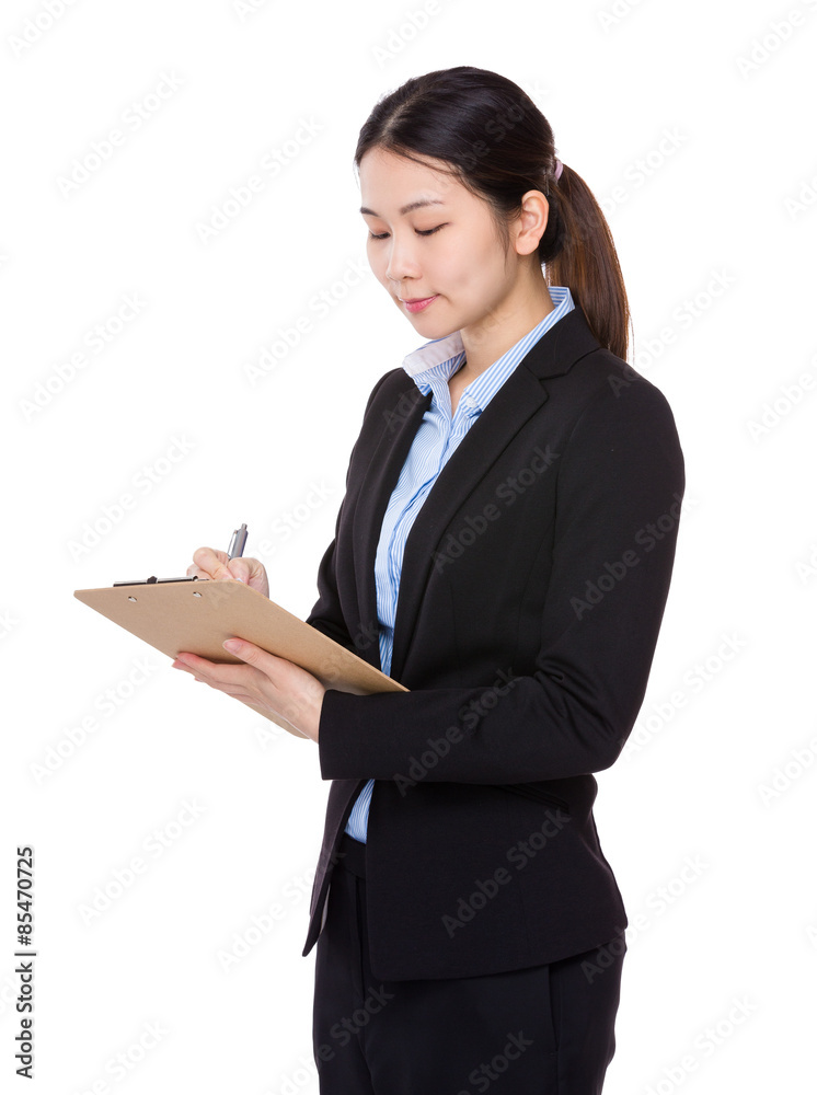 Businesswoman take note on clipboard Businesswoman take note on clipboard