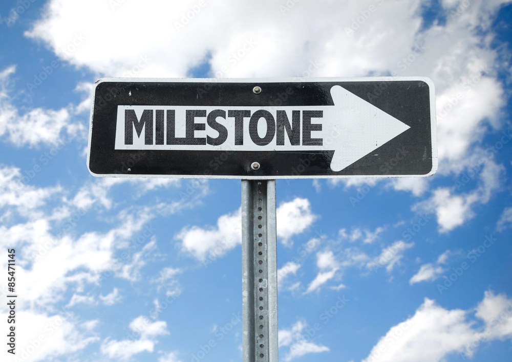 Milestone direction sign with sky background Milestone direction sign with sky background
