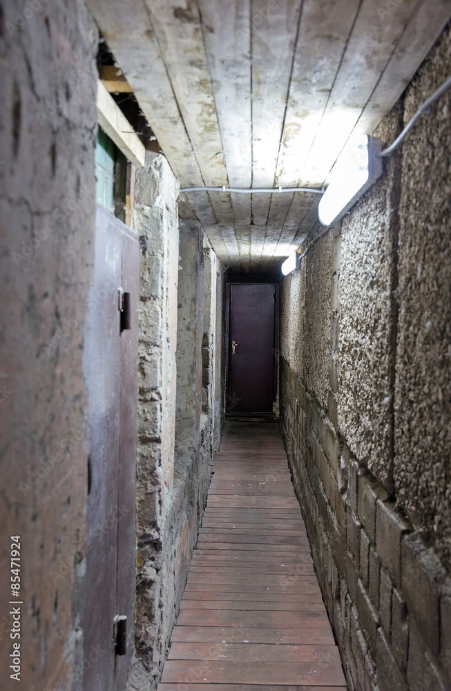 Gloomy corridor with the door closed underground