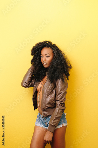 Fashion model in leather jacket and short jean shorts with necla