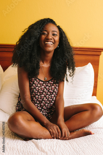 Smiling Happy Young Woman in Bed