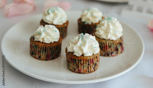 Fresh cup cakes on white plate