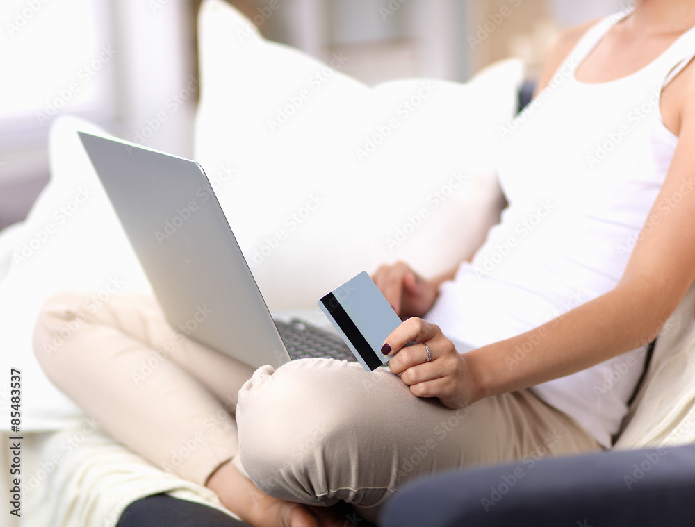 Fototapeta premium Woman shopping online with credit card and computer.