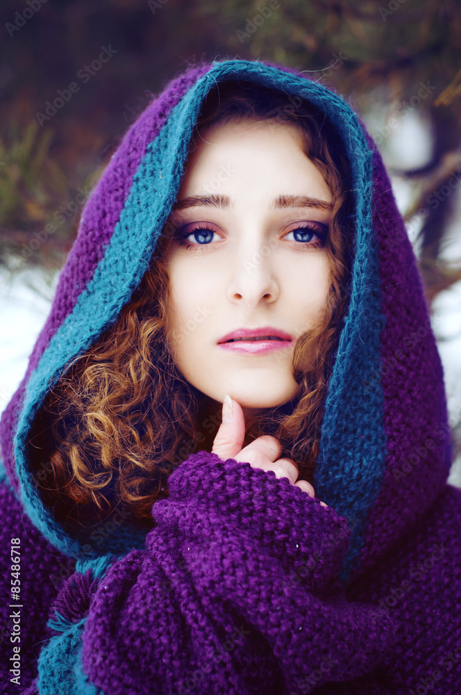 Mysterious young woman in purple cape with a hood Mysterious young woman in purple cape with a hood