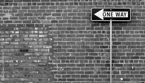 Slika na platnu One Way street sign in black and white with brick building