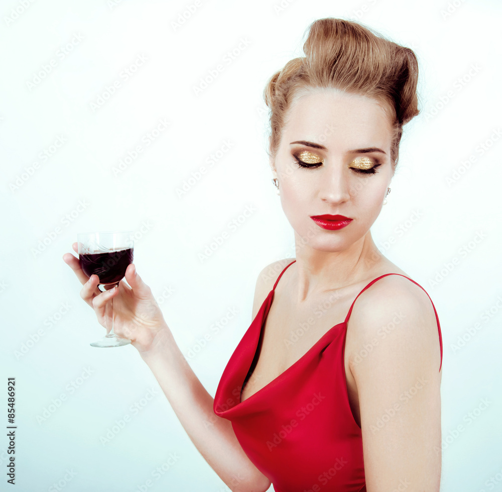 Beautiful sexy woman in red satin dress and red lips drinking vi Beautiful sexy woman in red satin dress and red lips drinking vi