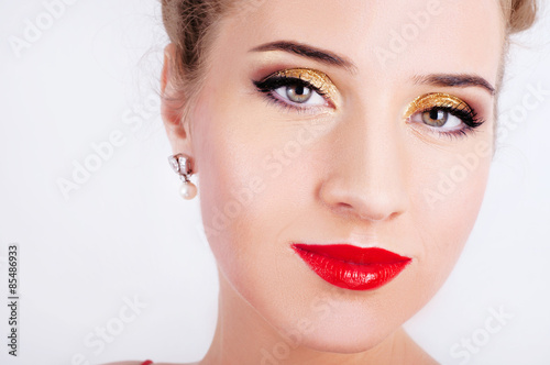 Beautiful sexy woman in red satin dress and red lips