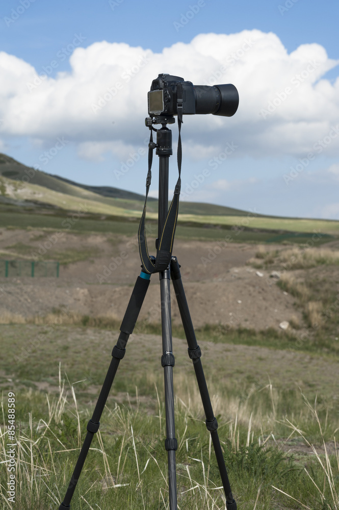 A camera with tripod in outside