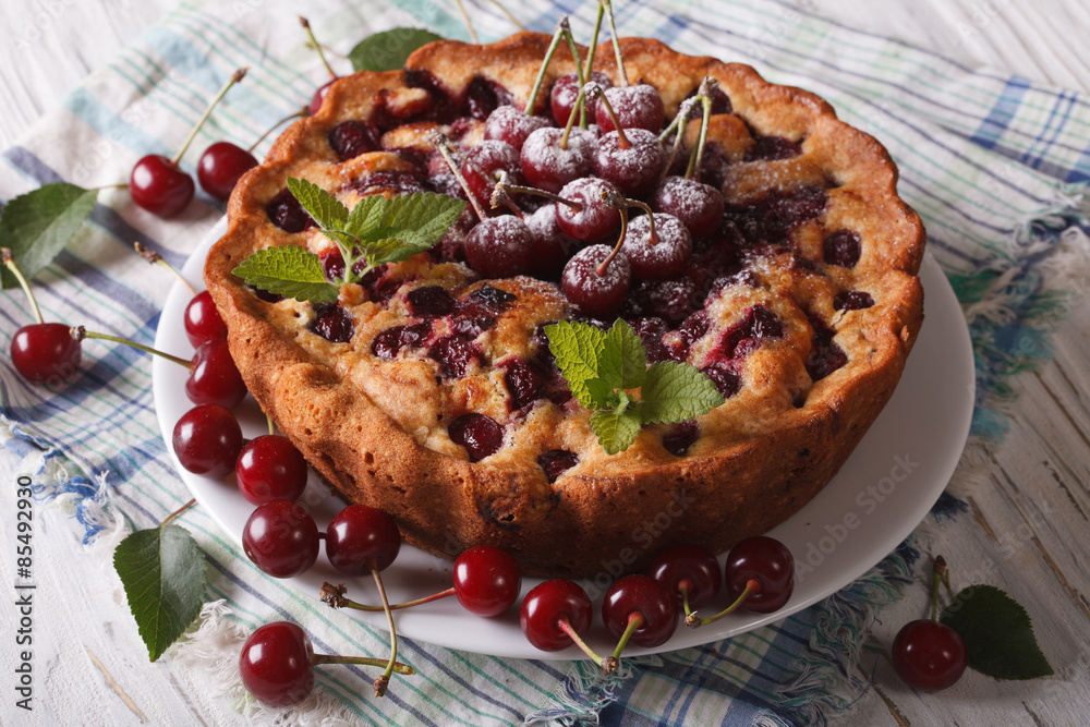 round cherry pie close up on a plate on the table. horizontal round cherry pie close up on a plate on the table. horizontal
