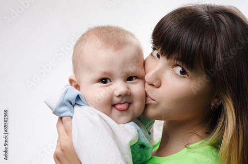 young mother playing with baby