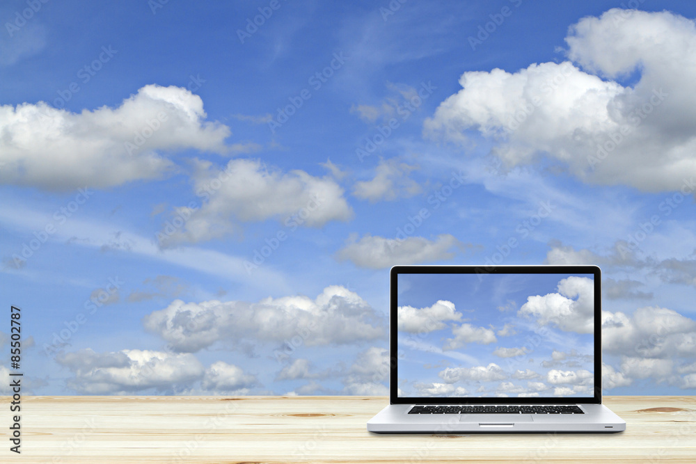 Laptop computer on wooden floor with sky background. White screen Laptop computer on wooden floor with sky background. White screen