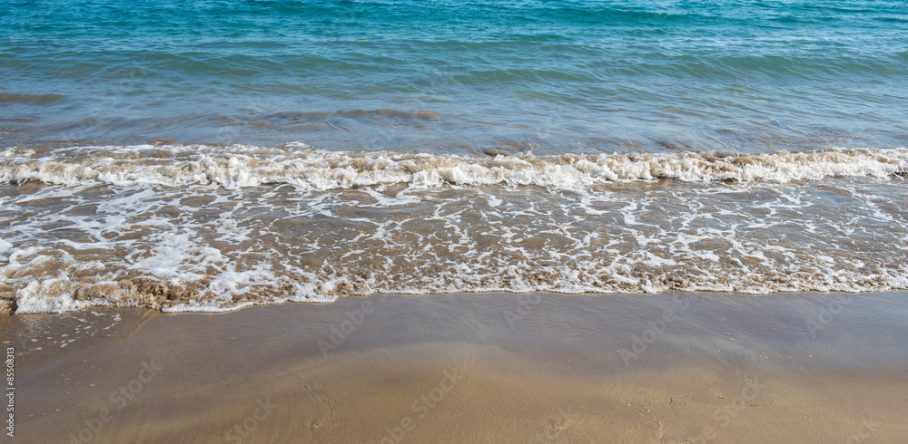 Seashore wave with sandy beach  background