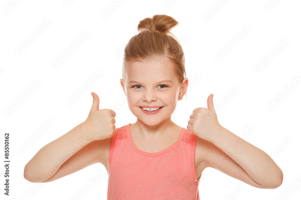 Happy joyful little girl smiling showing thumbs up, isolated on white background Happy joyful little girl smiling showing thumbs up, isolated on white background