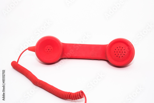 A red telephone receiver on white background.