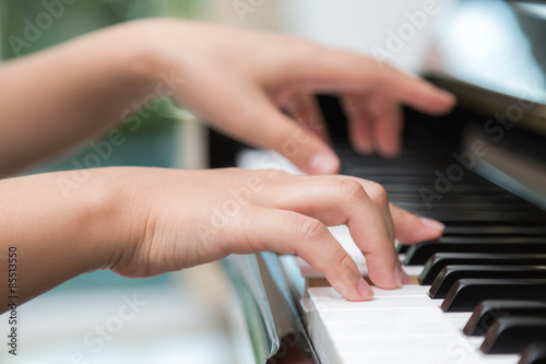 Close up of woman hands playing piano