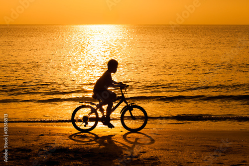 Cyclist rides at sunset.