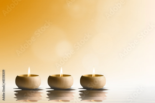 Zen concept. Candles on orange background.