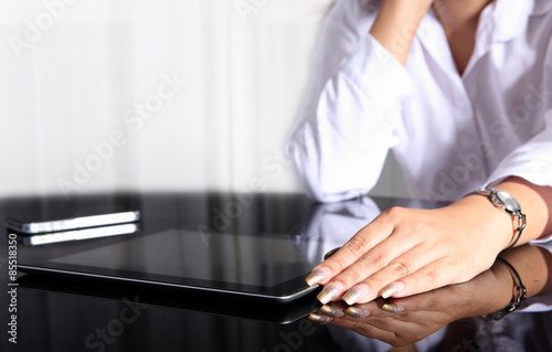 tablet pc on office table and woman waiting something