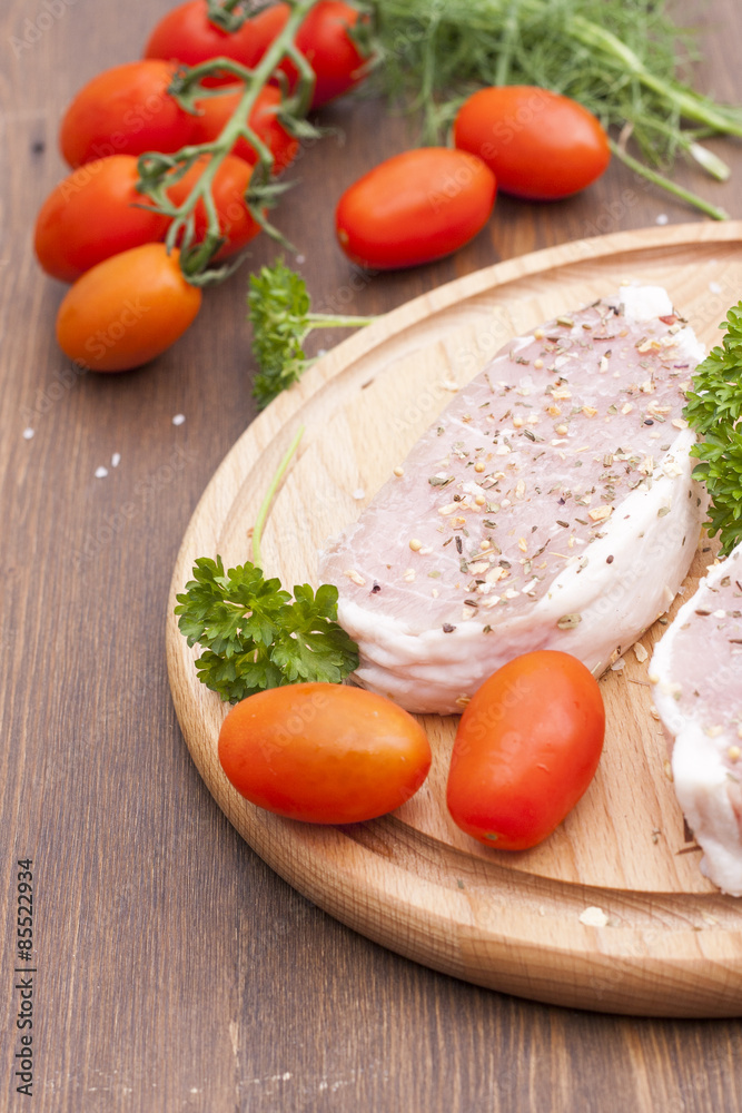 Fresh Raw Steak Meat with spaces, herbs and vegetables, selective focus Fresh Raw Steak Meat with spaces, herbs and vegetables, selective focus