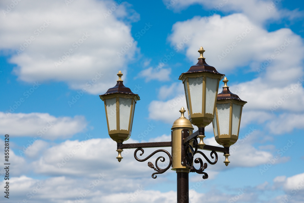 Lantern on blue cloudy sky background