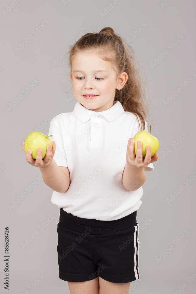 Little girl holding two apples Little girl holding two apples