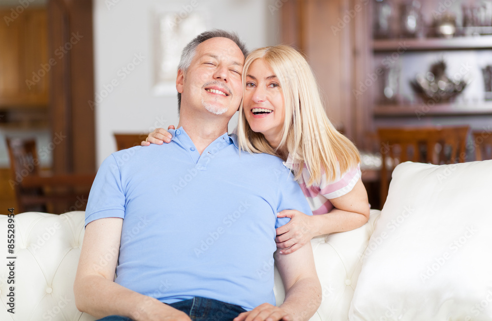Senior Couple Relaxing On Sofa At Home Senior Couple Relaxing On Sofa At Home