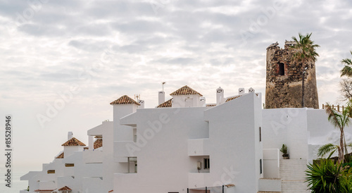 Rooftops of the spanish condominium and tower against cloudy sky. Malaga, Spain