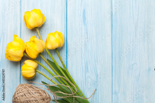 Fototapeta Naklejka Na Ścianę i Meble -  Yellow tulips over wooden table