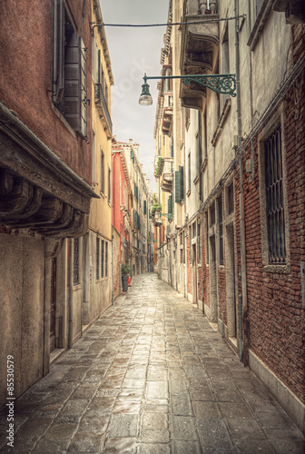 typical narrow alley in street of Venice  Venezia  at a rainy day  vintage style  Italy  Europe