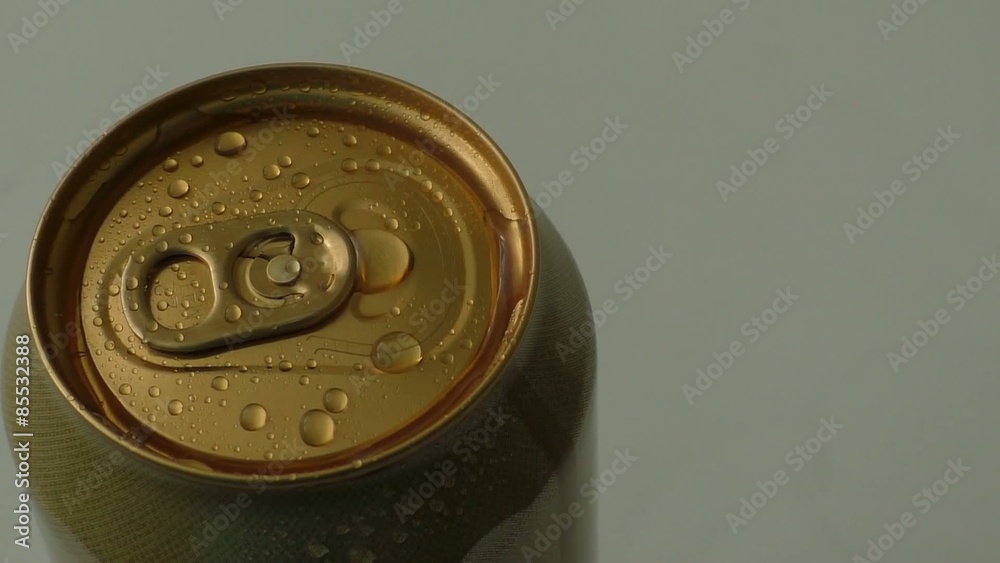 Golden beer can with water drops close up
Golden beer can with water drops close up