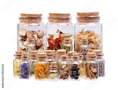 Herbal tea, dried herbs, flowers and berries in glass bottles fo