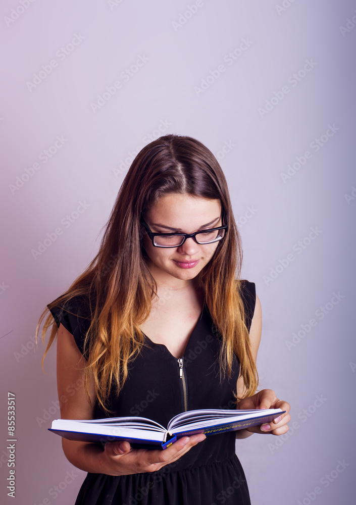 young caucasian female with books on grey background, education concept