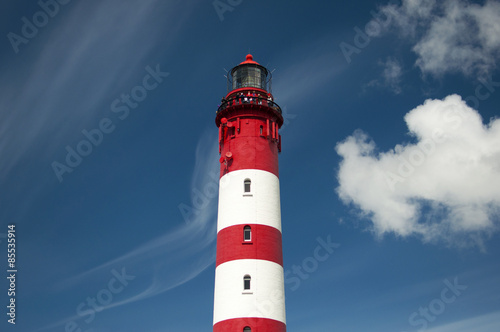 Lighthouse and dunes against beautiful sky at the German North Sea island Amrum, Germany, Europe