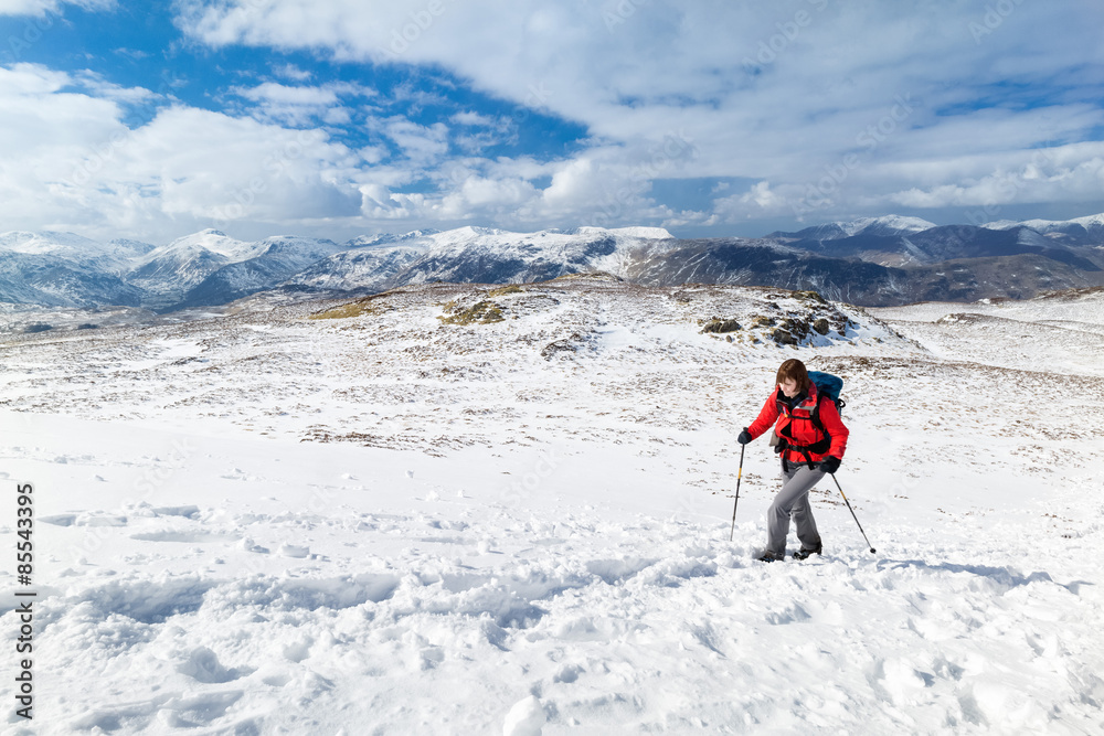 Female hiker on a winter mountain walk.