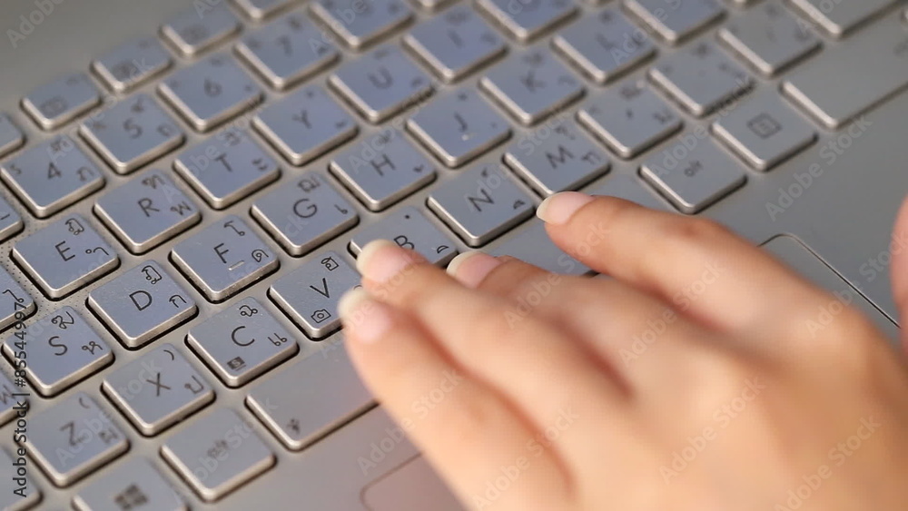 hand pressing The Space Bar button in laptop keyboard