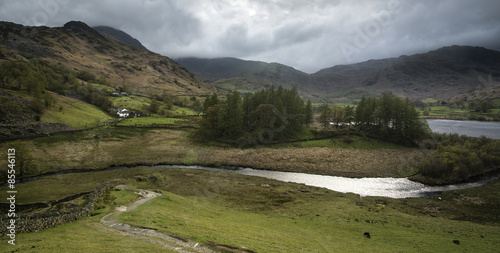 Stormy dramatic sky over Lake District countryside landscape