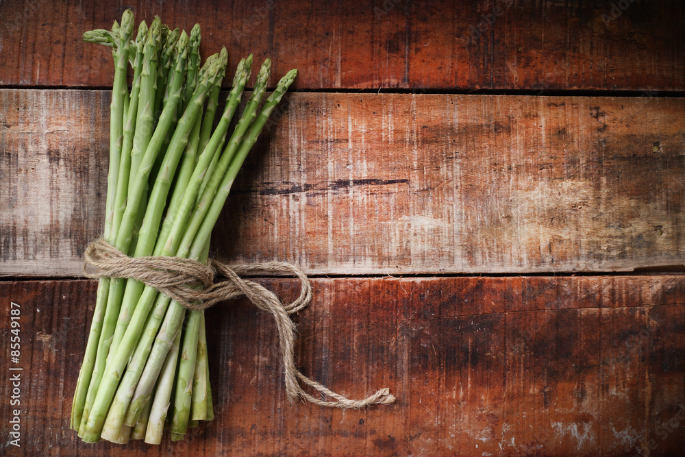 Bunch of fresh asparagus on wooden table Bunch of fresh asparagus on wooden table