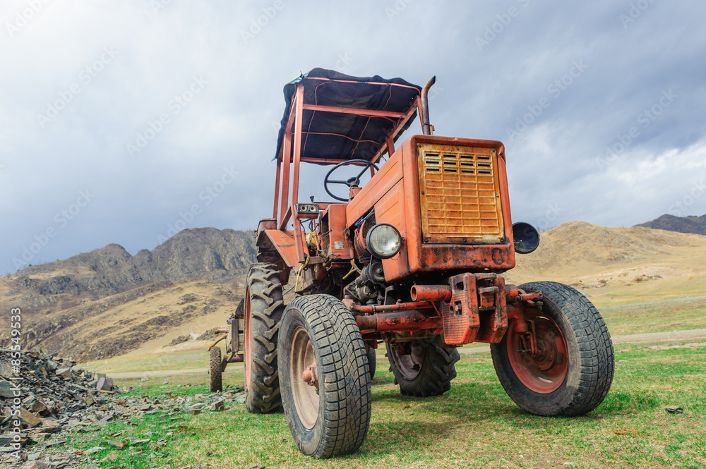 Obraz premium Lonely old tractor in Altai steppe in rainy day