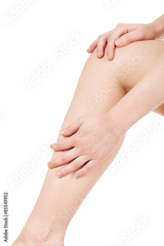 Fototapeta Naklejka Na Ścianę i Meble -  Woman massaging her leg.