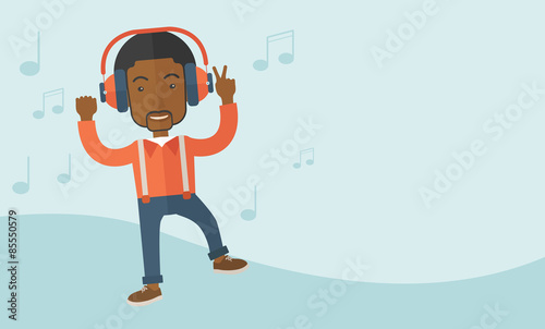 Happy young man dancing while listening to music.