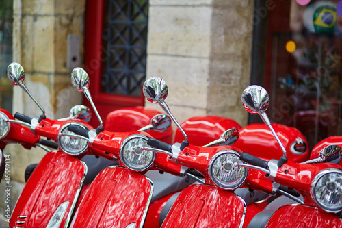 Fotografie Red retro scooters parked on a Parisian street