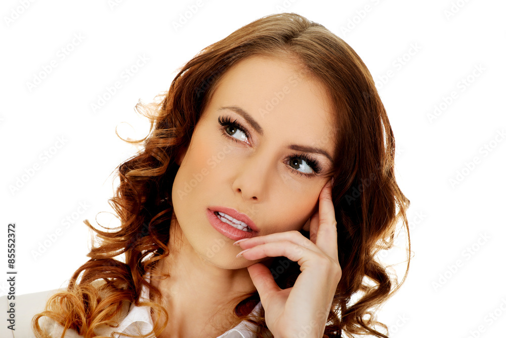 Thoughtful businesswoman looking up. Thoughtful businesswoman looking up.