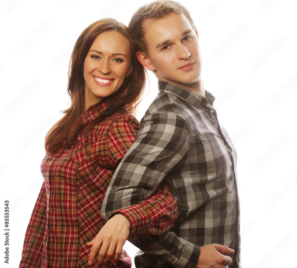 lovely happy couple hugging over grey background. lovely happy couple hugging over grey background.