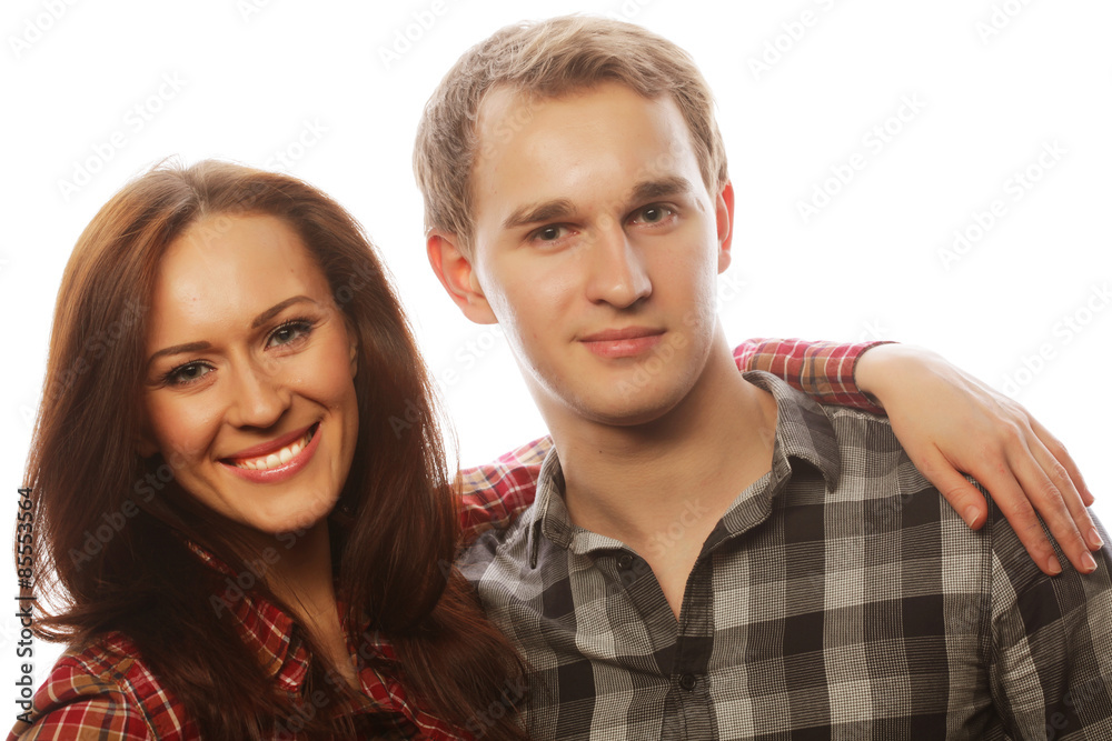 lovely happy couple hugging over grey background. lovely happy couple hugging over grey background.