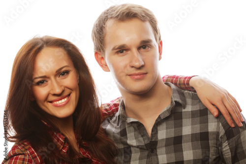 lovely happy couple hugging over grey background.