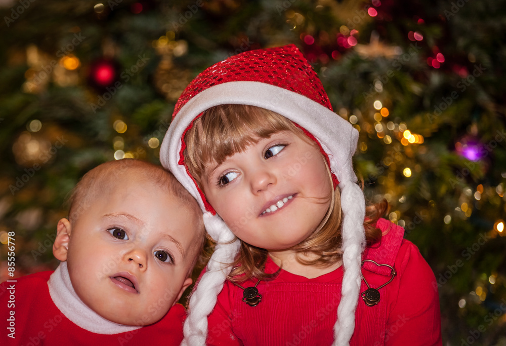 Brother and sister under Christmas tree Brother and sister under Christmas tree