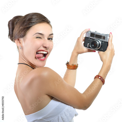 Beautiful girl takes her self picture with retro photo camera  o