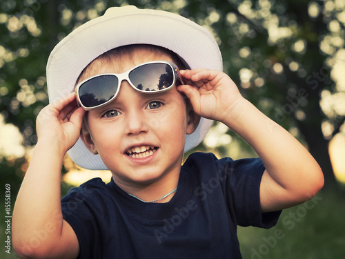 Portrait of a cheerful little boy in sunglasses