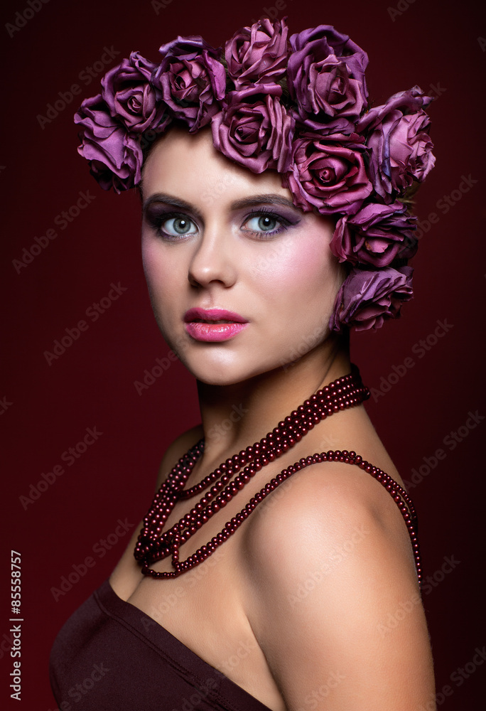 Beautiful young woman with artificial rouses on head necklace an Beautiful young woman with artificial rouses on head necklace an
